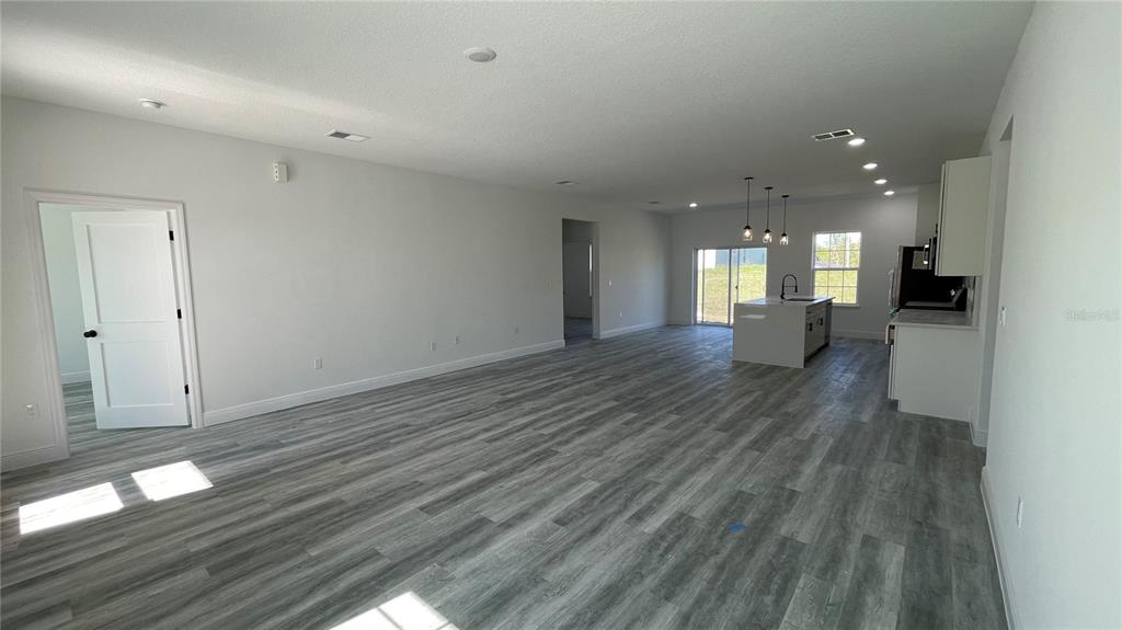 15282 Southwest 65th Avenue Road Ocala, FL 34473 - Photo 10 of 33 a view of a hallway with wooden floor