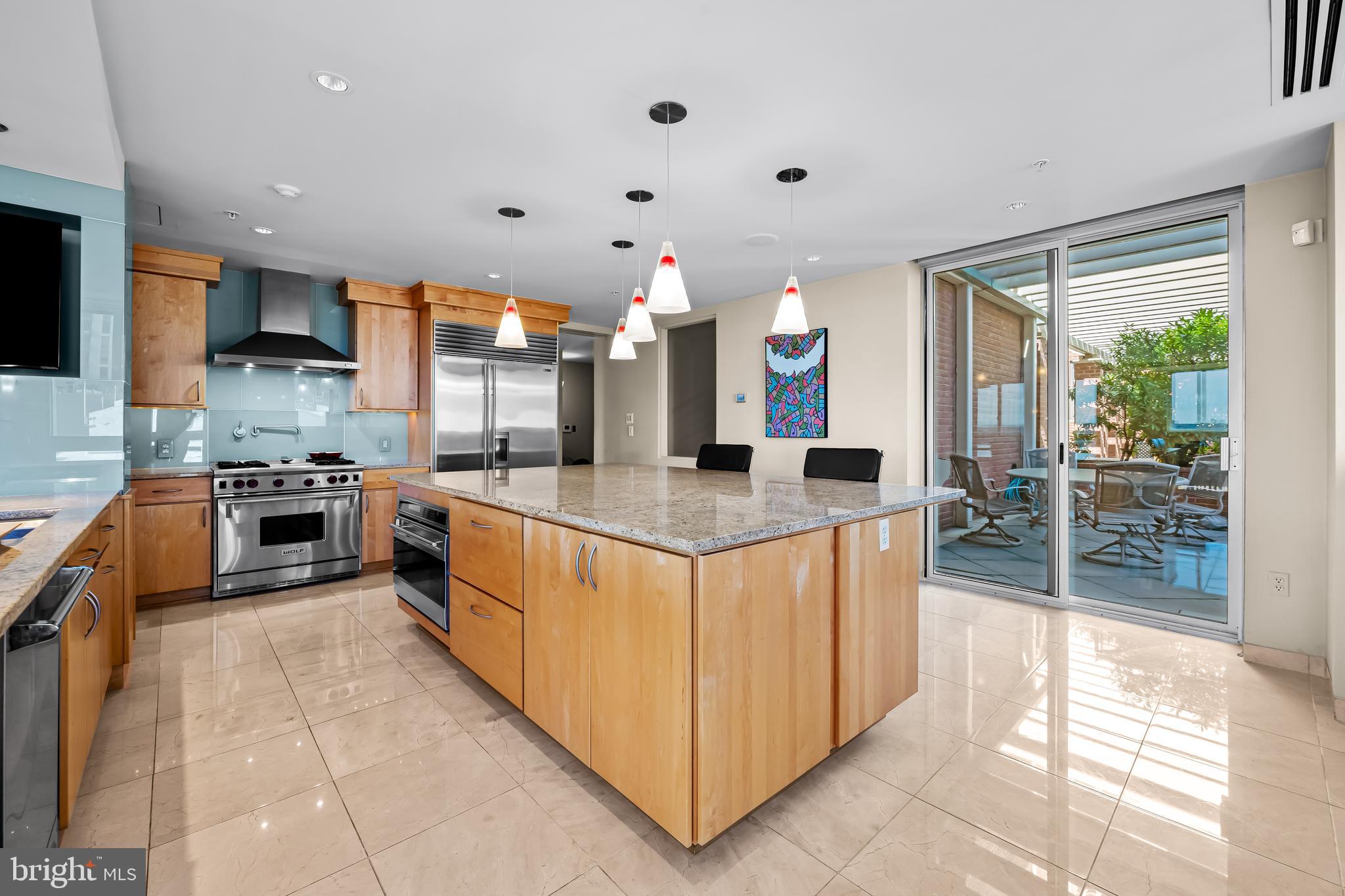717 President Street, Unit PH802 Baltimore, MD 21202 - Photo 17 of 77 a kitchen with stainless steel appliances granite countertop a stove and a sink