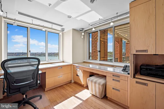 a spacious bedroom with a bed and wooden floor