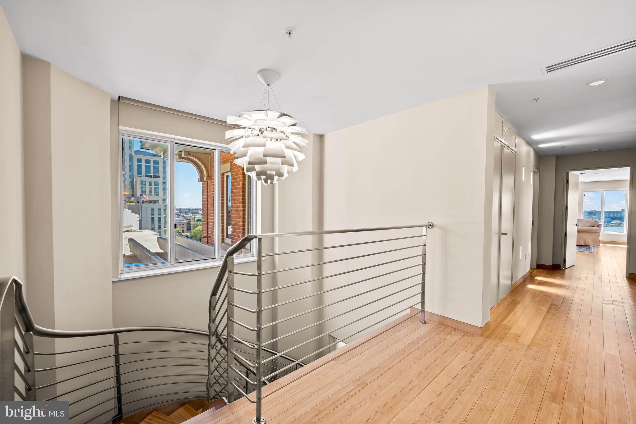 717 President Street, Unit PH802 Baltimore, MD 21202 - Photo 32 of 77 a view of a livingroom with wooden floor and stairs