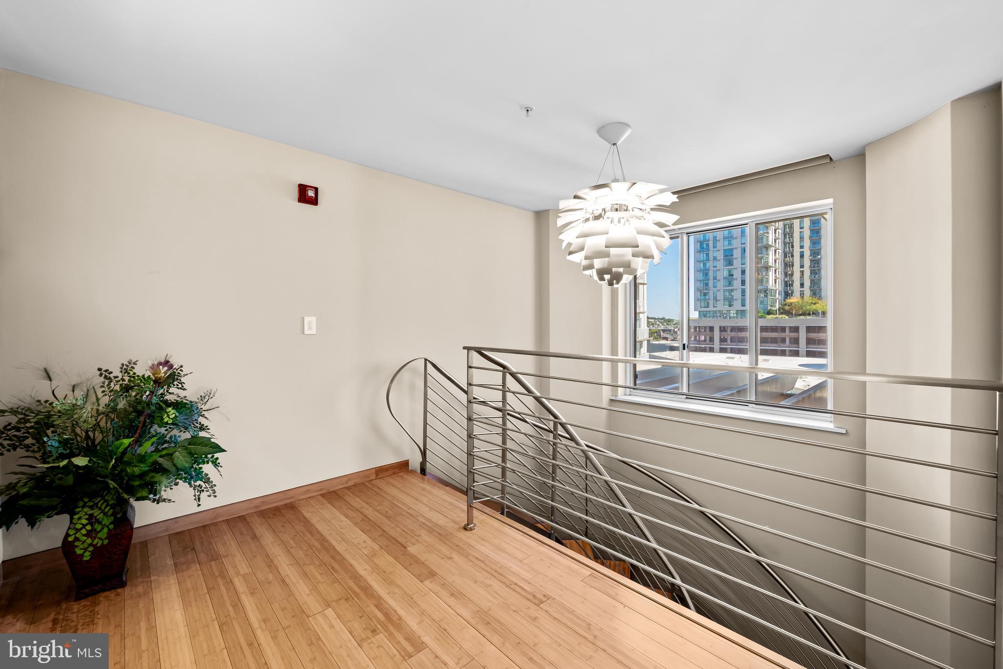 717 President Street, Unit PH802 Baltimore, MD 21202 - Photo 33 of 77 a very nice looking room with a large window and wooden floor