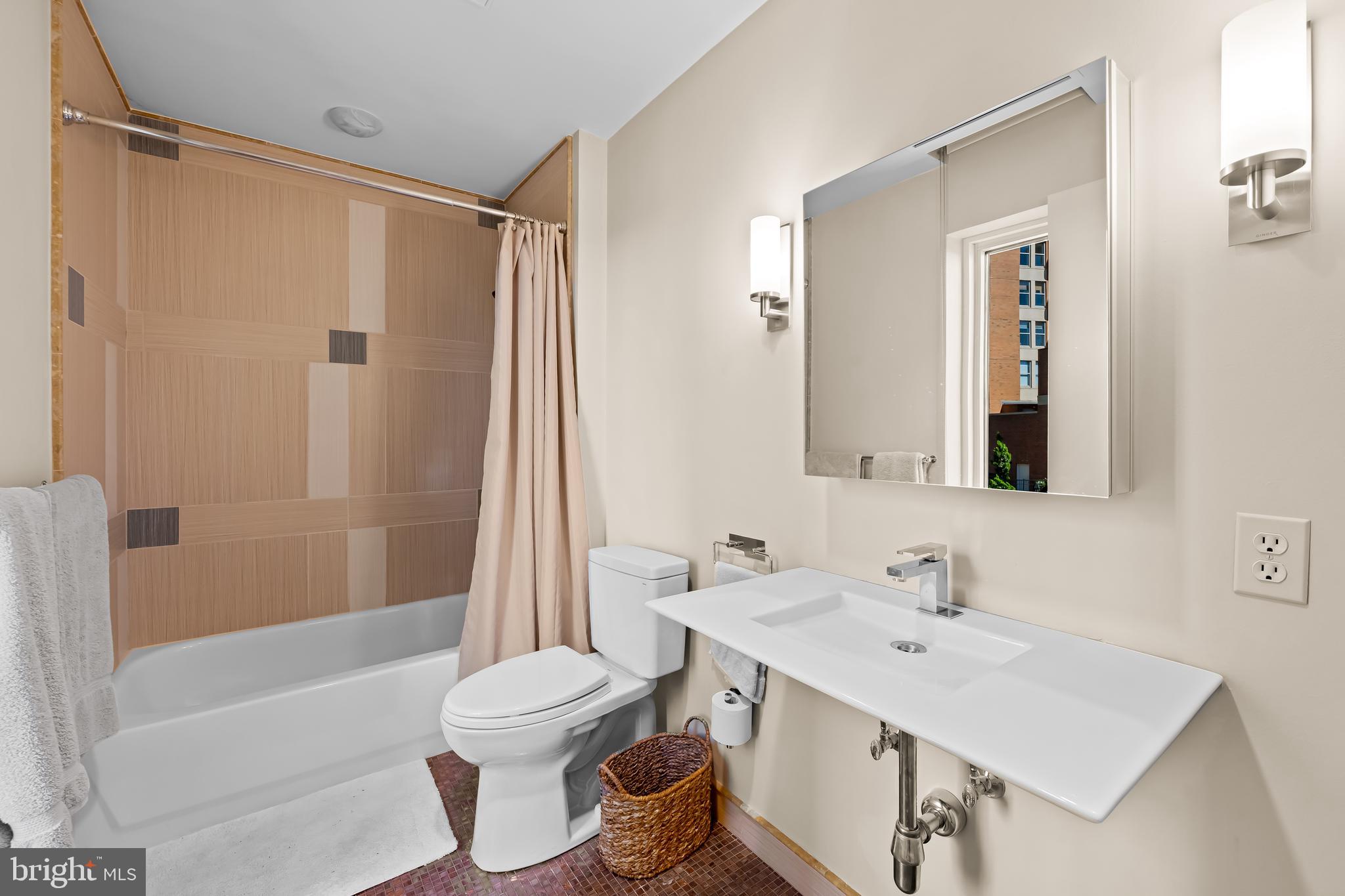 717 President Street, Unit PH802 Baltimore, MD 21202 - Photo 46 of 77 a bathroom with a sink toilet and shower