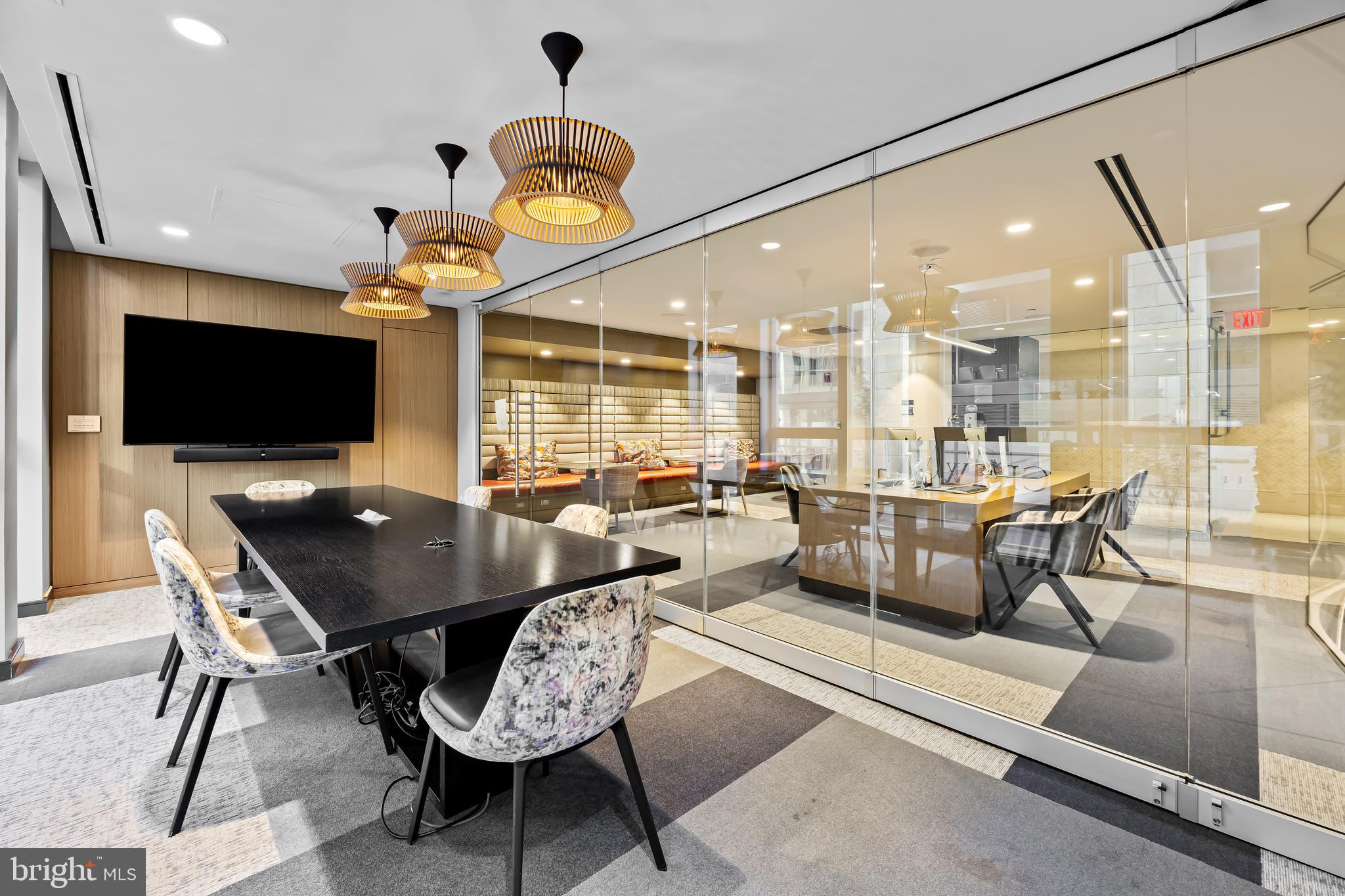 717 President Street, Unit PH802 Baltimore, MD 21202 - Photo 69 of 77 a living room with couches a flat screen tv and kitchen view