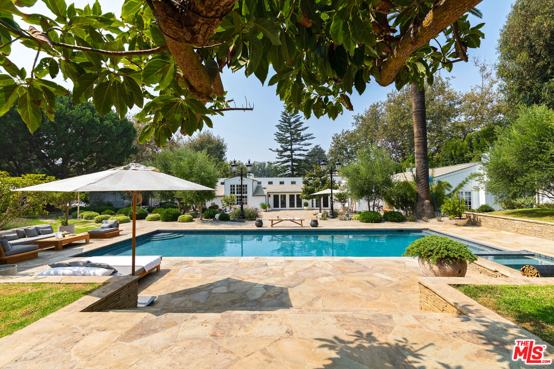6238 Bonsall Drive Malibu, CA 90265 - Photo 1 of 40 a view of a swimming pool with a patio and a garden