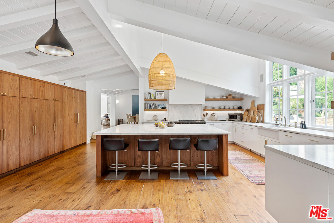6238 Bonsall Drive Malibu, CA 90265 - Photo 11 of 40 a living room with a table chairs and a large window
