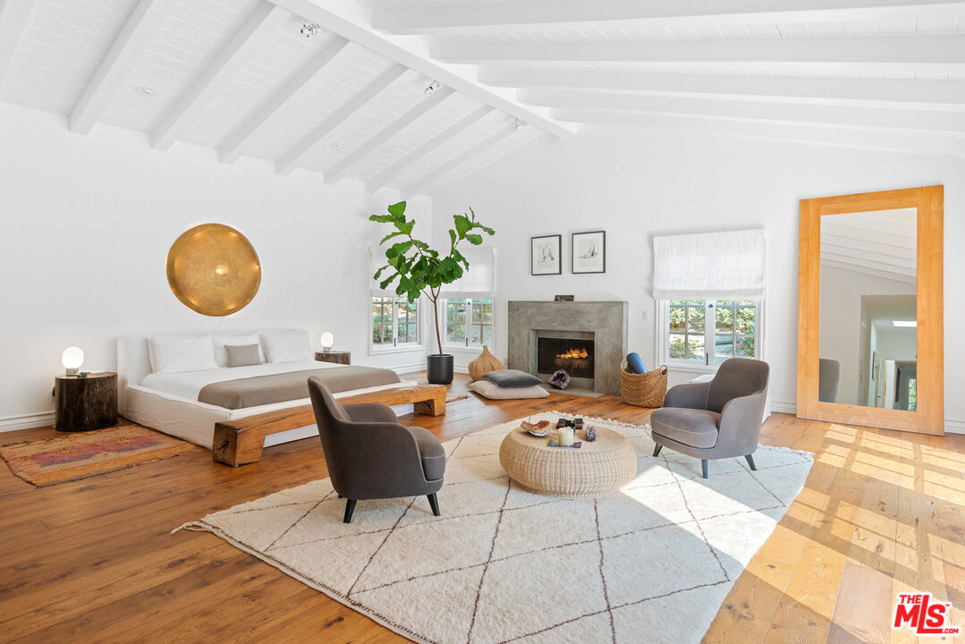 6238 Bonsall Drive Malibu, CA 90265 - Photo 14 of 40 a living room with fireplace furniture and a large window
