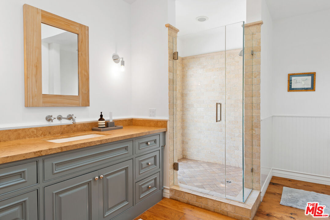 6238 Bonsall Drive Malibu, CA 90265 - Photo 18 of 40 a bathroom with a shower sink and mirror