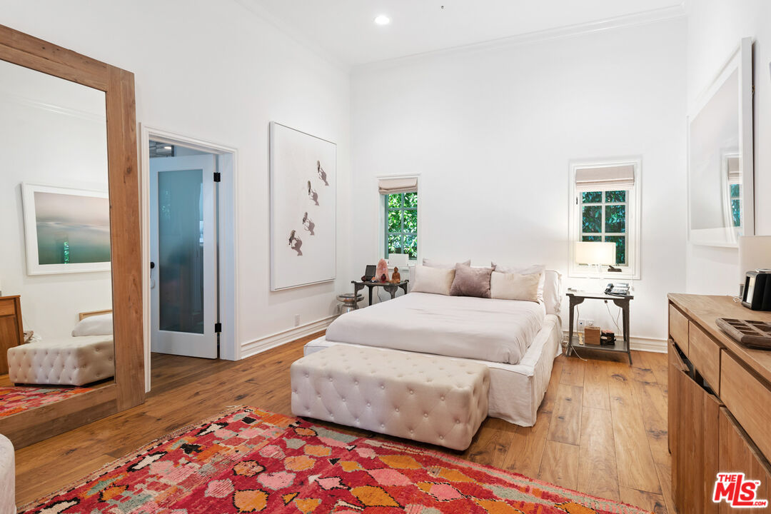 6238 Bonsall Drive Malibu, CA 90265 - Photo 20 of 40 a bedroom with a bed and wooden floor
