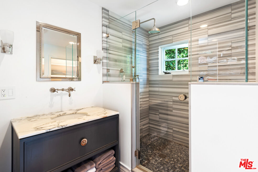 6238 Bonsall Drive Malibu, CA 90265 - Photo 21 of 40 a bathroom with a sink vanity and a mirror