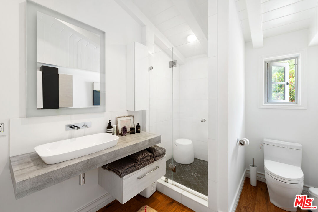 6238 Bonsall Drive Malibu, CA 90265 - Photo 23 of 40 a bathroom with a sink toilet and mirror