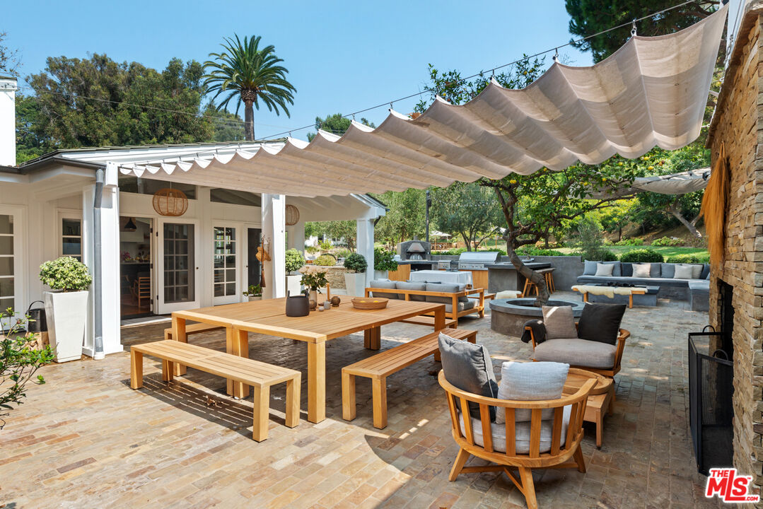6238 Bonsall Drive Malibu, CA 90265 - Photo 24 of 40 a view of a patio with swimming pool table and chairs