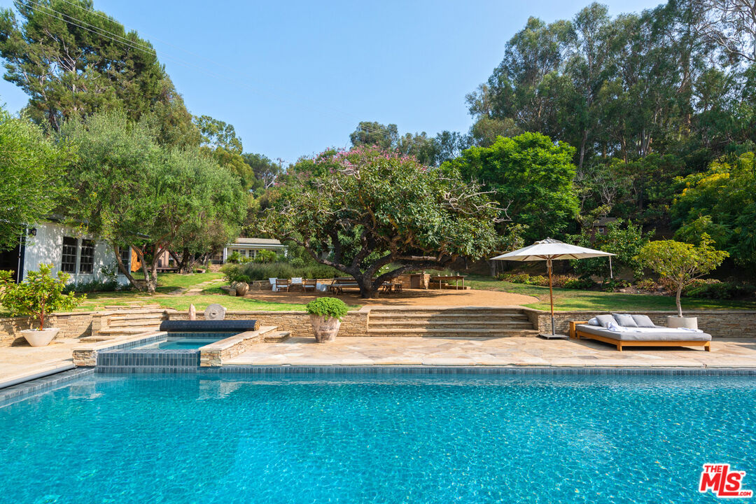 6238 Bonsall Drive Malibu, CA 90265 - Photo 27 of 40 a swimming pool with outdoor seating and yard