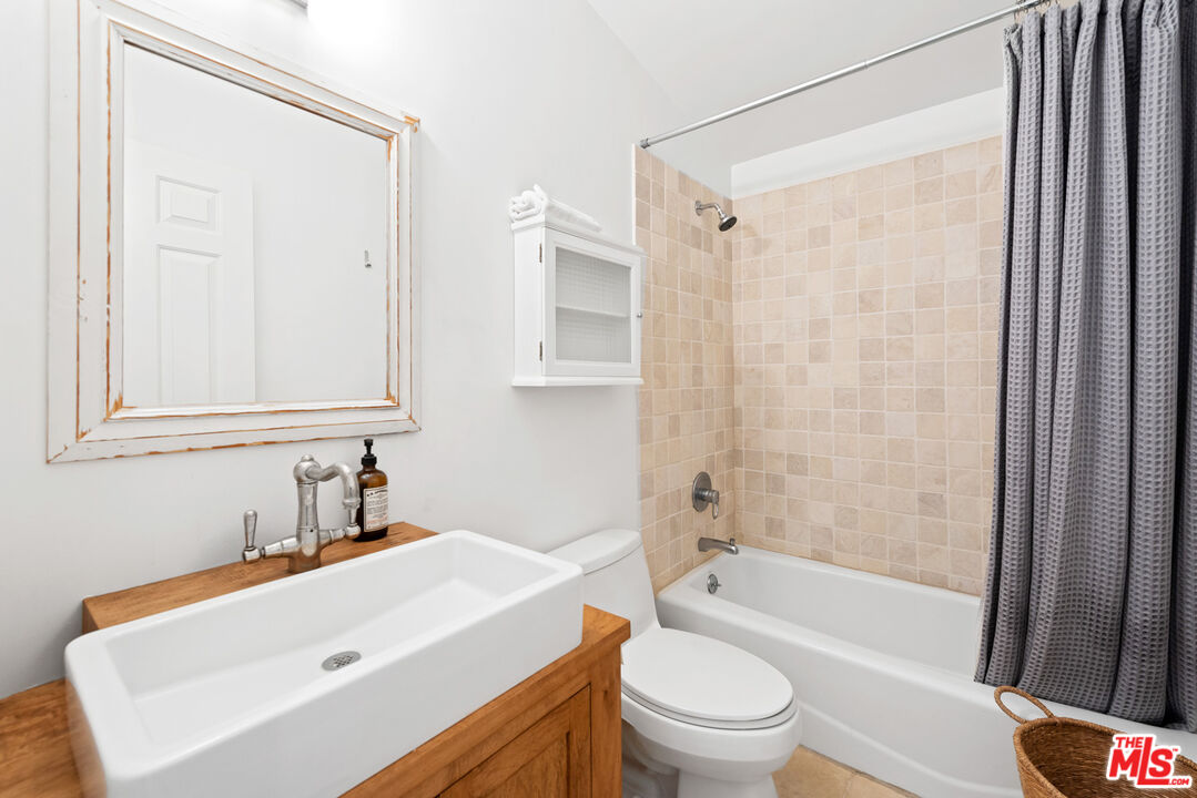 6238 Bonsall Drive Malibu, CA 90265 - Photo 32 of 40 a bathroom with a sink a toilet a mirror and a shower