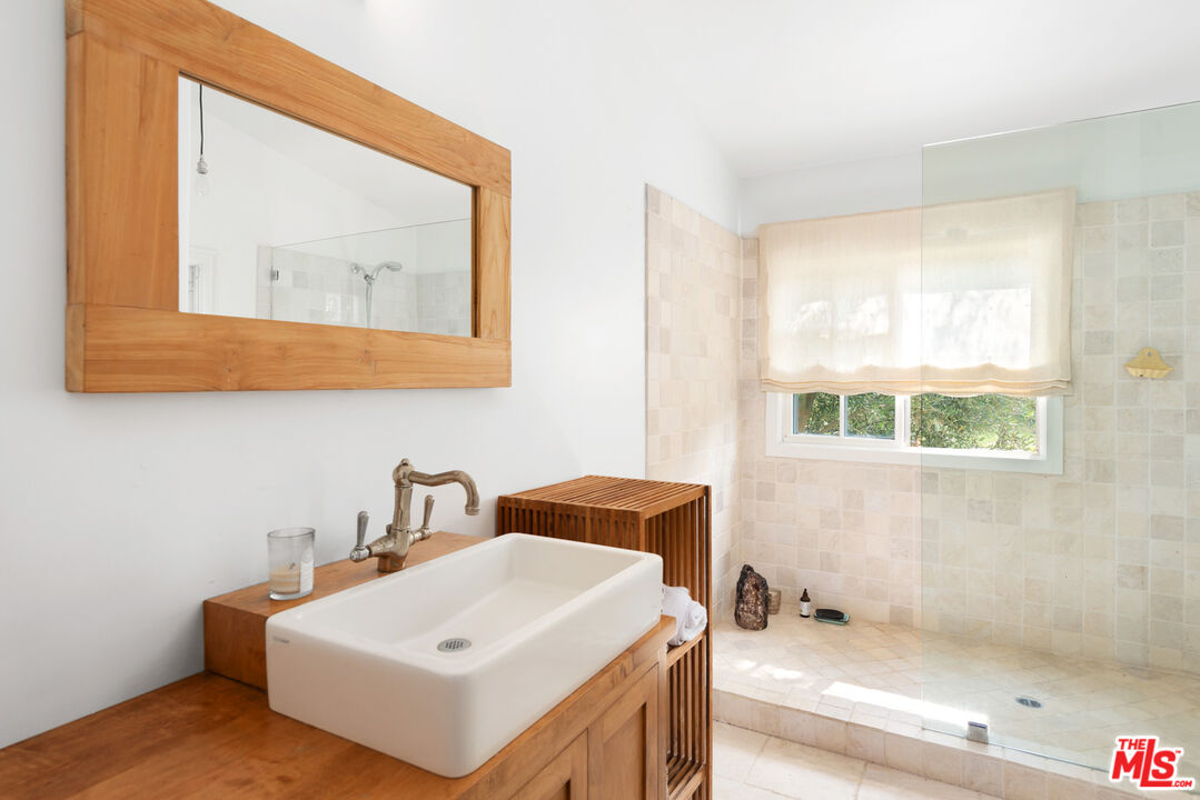 6238 Bonsall Drive Malibu, CA 90265 - Photo 34 of 40 a bathroom with a sink a vanity and a mirror