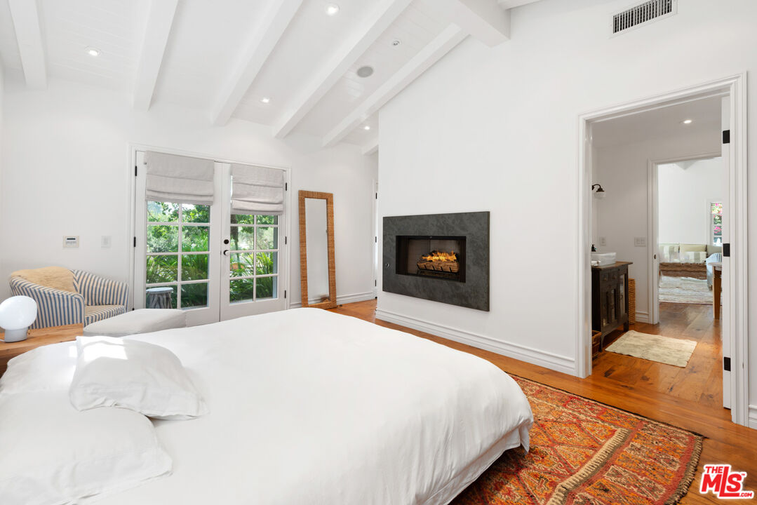 6238 Bonsall Drive Malibu, CA 90265 - Photo 39 of 40 a bedroom with a bed and a fireplace