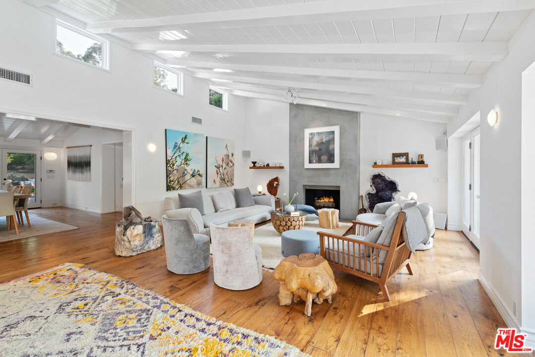 6238 Bonsall Drive Malibu, CA 90265 - Photo 7 of 40 a living room with fireplace furniture and a wooden floor