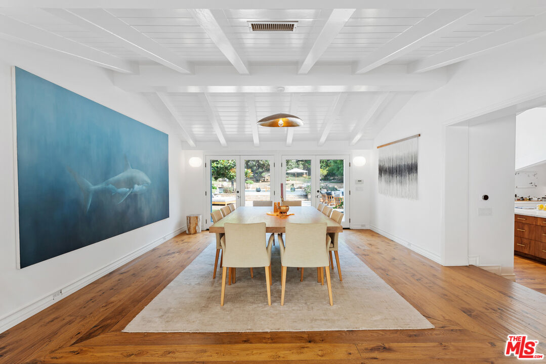 6238 Bonsall Drive Malibu, CA 90265 - Photo 9 of 40 a dining room with wooden floor and white walls