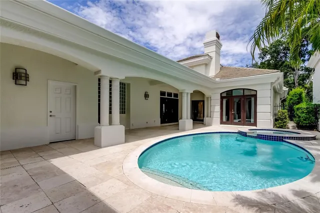 a view of a lake with a yard and large trees