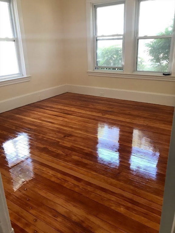 28 Beaconsfield Road, Unit 1 Brookline, MA 02445 - Photo 13 of 21 a view of empty room with wooden floor and fan
