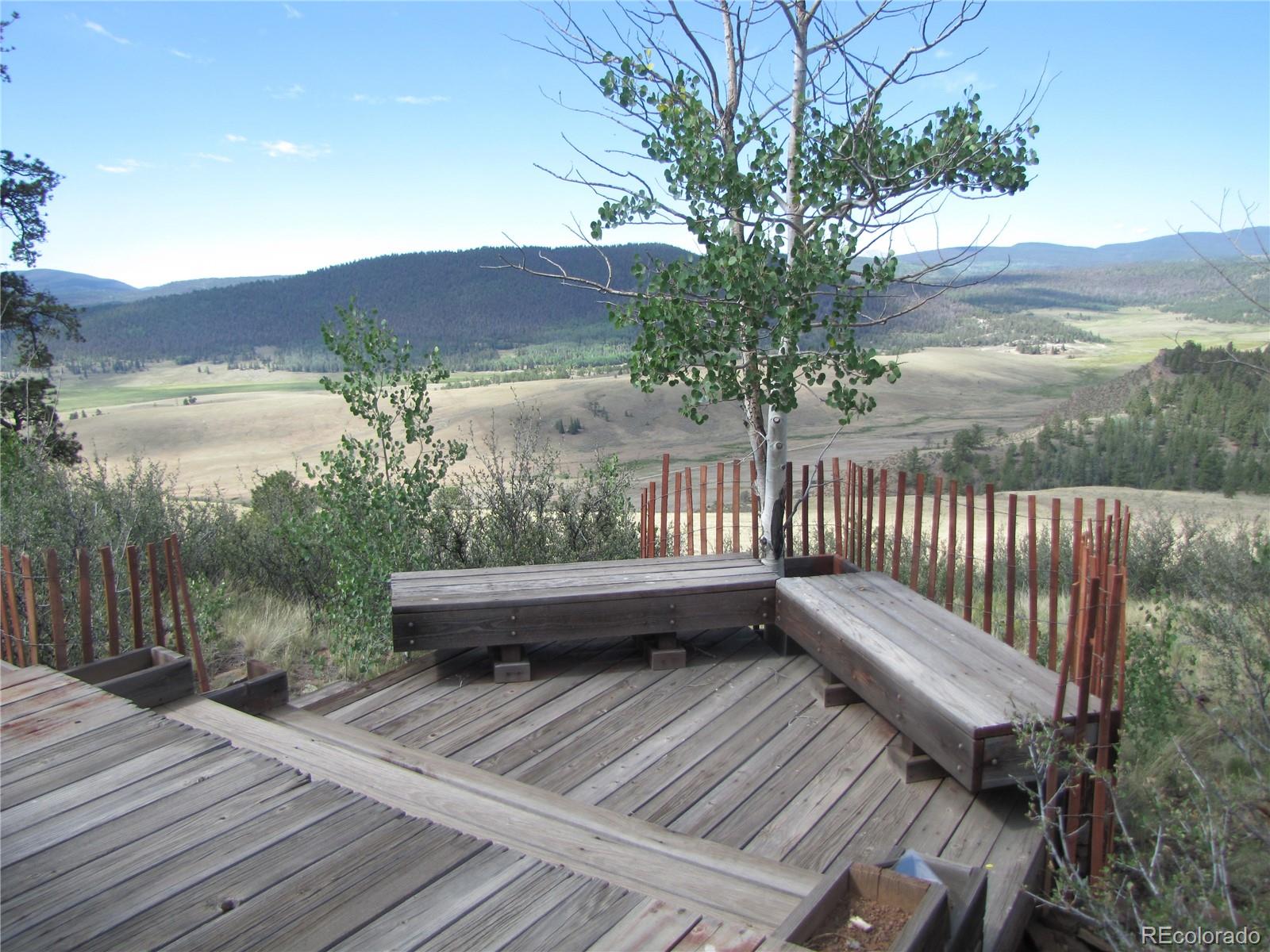 1808 Narrow Gauge Road Fairplay, CO 80440 - Photo 2 of 33 a view of a balcony with chairs and wooden floor