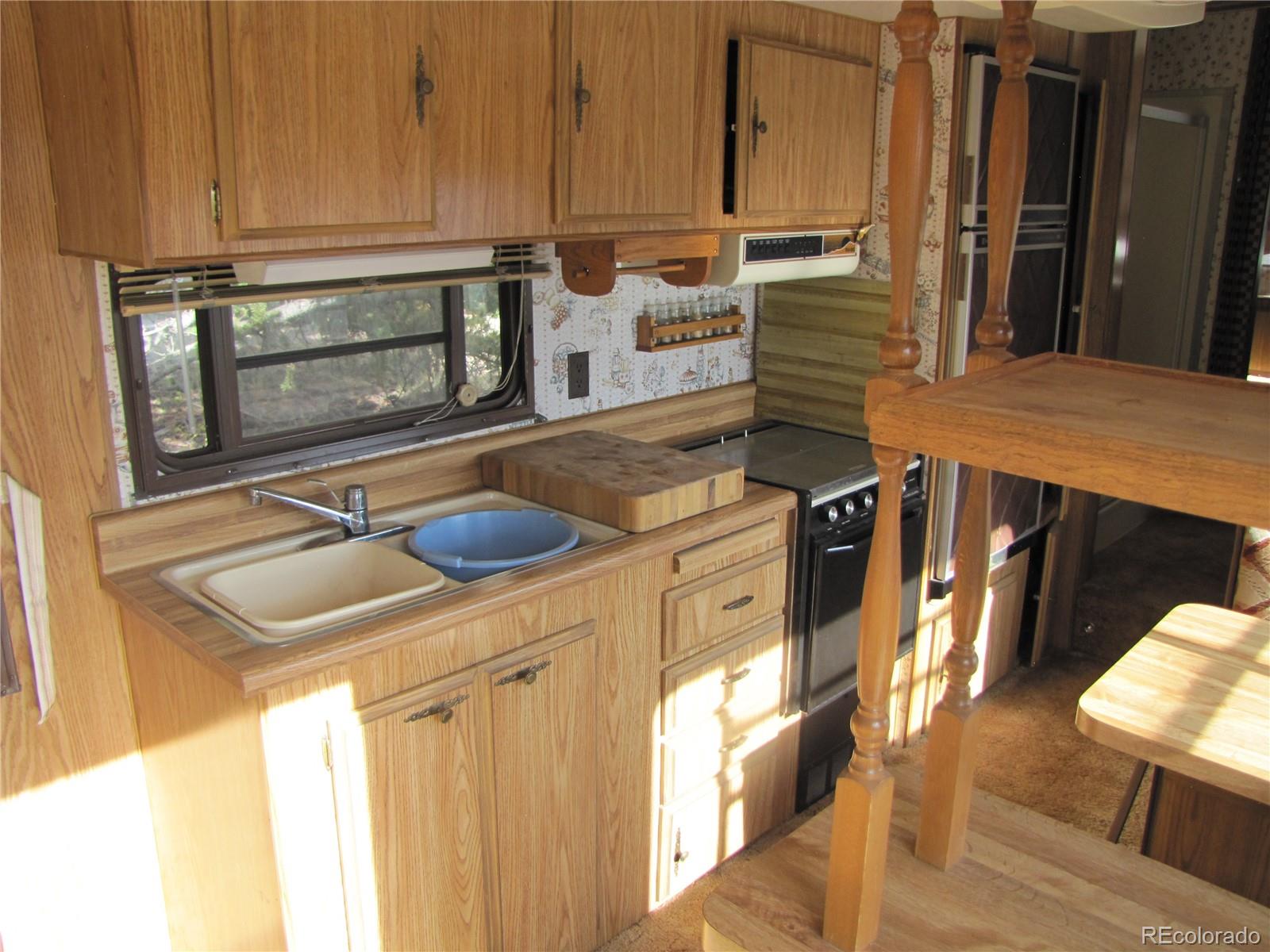 1808 Narrow Gauge Road Fairplay, CO 80440 - Photo 29 of 33 a kitchen with stainless steel appliances granite countertop a sink and a refrigerator