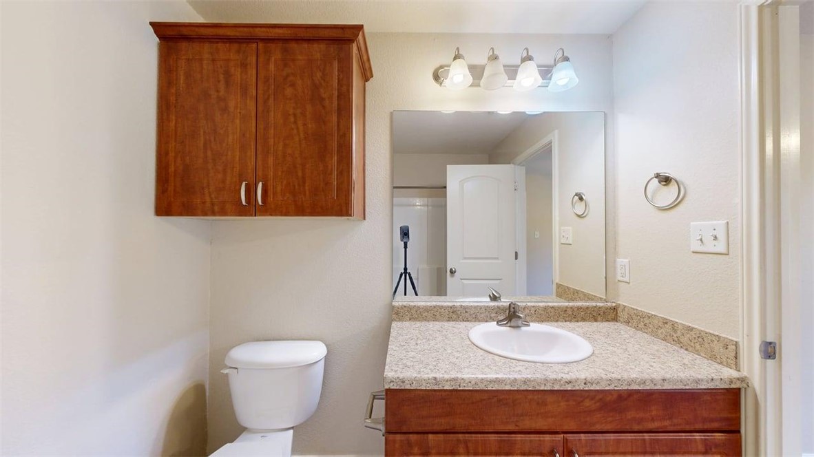 4436 Reveille Road College Station, TX 77845 - Photo 19 of 31 a bathroom with a granite countertop sink and a mirror