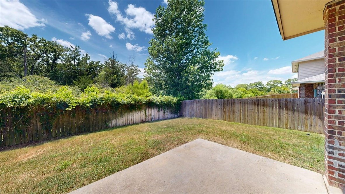 4436 Reveille Road College Station, TX 77845 - Photo 26 of 31 a backyard of a house with lots of green space and lake view