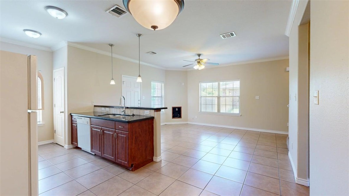 4436 Reveille Road College Station, TX 77845 - Photo 30 of 31 a kitchen with stainless steel appliances granite countertop a stove and a sink