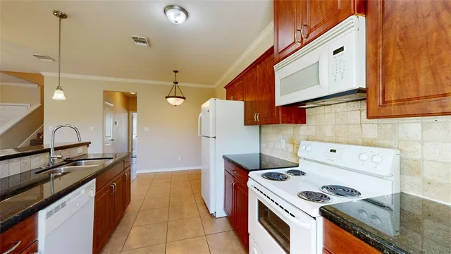 a view of a double sink and chandelier
