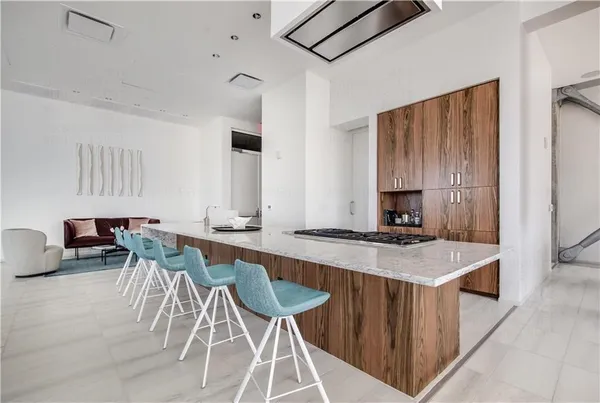 a kitchen with a stove a table and chairs