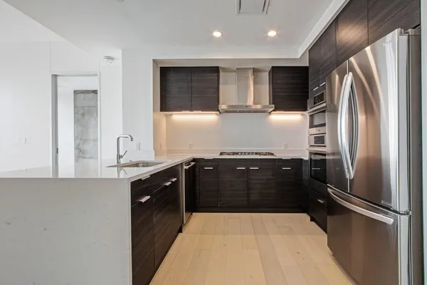 a kitchen with a refrigerator and a sink