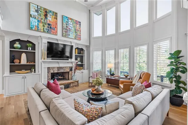 a living room with furniture a rug and a large window
