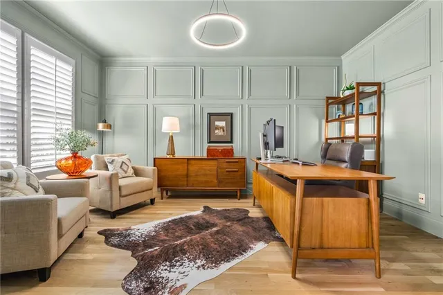 a spacious bedroom with a bed a couch and potted plant on the dresser