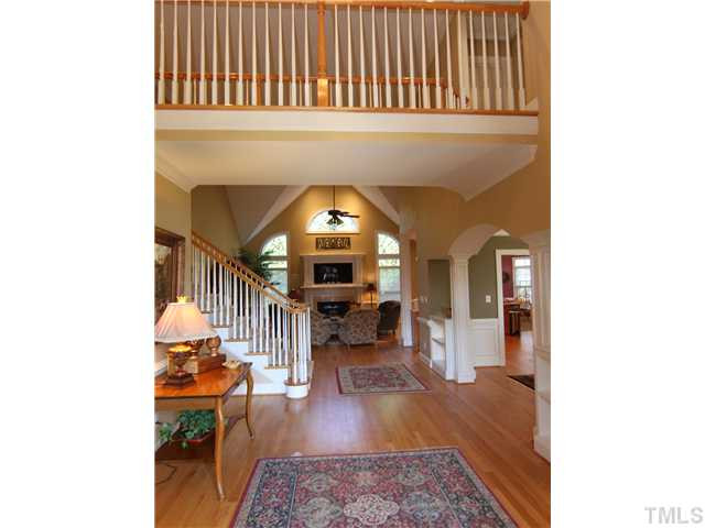12501 Ribbongrass Court Raleigh, NC 27614 - Photo 3 of 25 Gorgeous open foyer with gleaming hardwoods. To the right is the living room and further up on right is formal dining room. Note the 2 story ceiling in the family room up ahead. Foyer