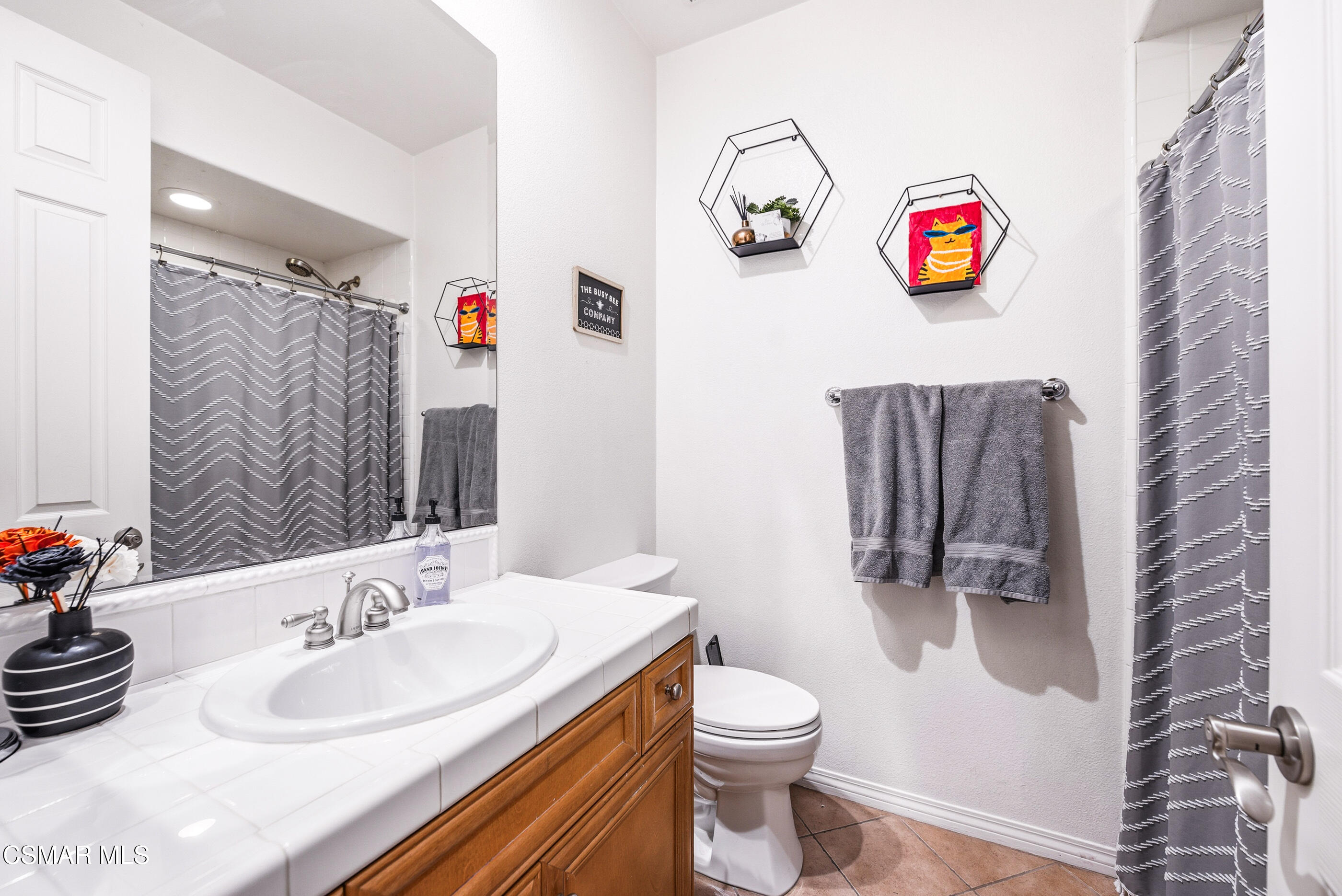 4741 Westwood Street Simi Valley, CA 93063 - Photo 20 of 48 a bathroom with a sink a toilet and a shower curtain