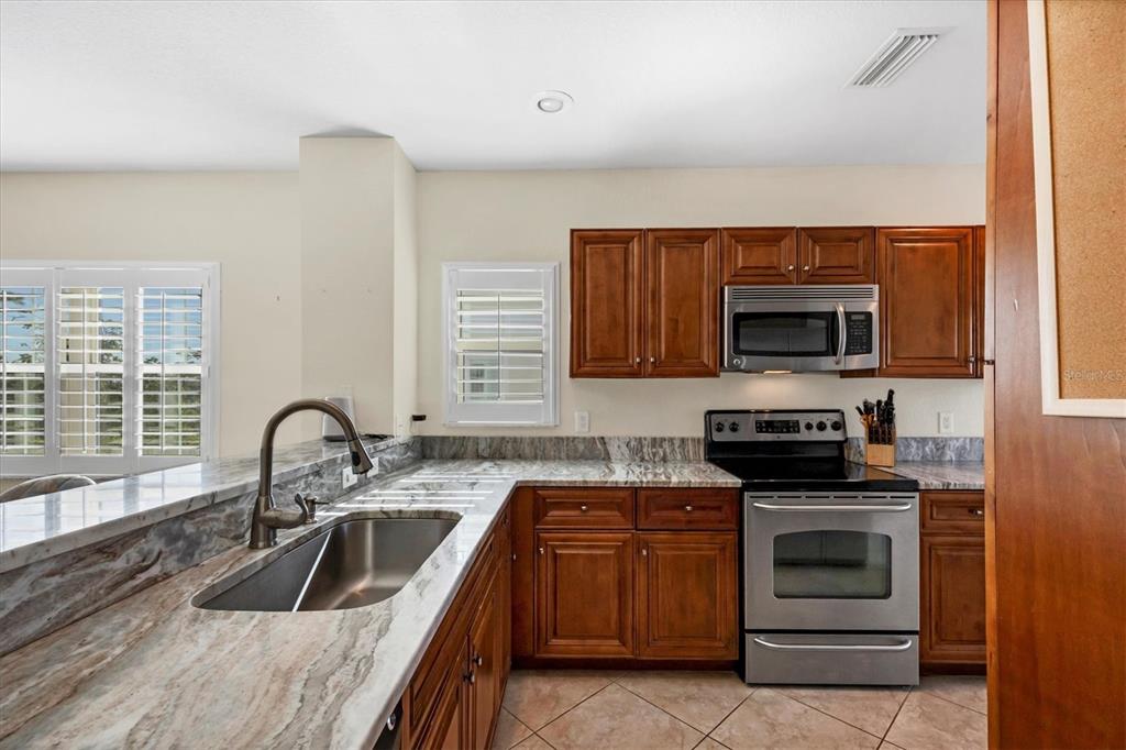 8413 Placida Road, Unit 308 Placida, FL 33946 - Photo 12 of 40 a kitchen with a sink a stove and microwave