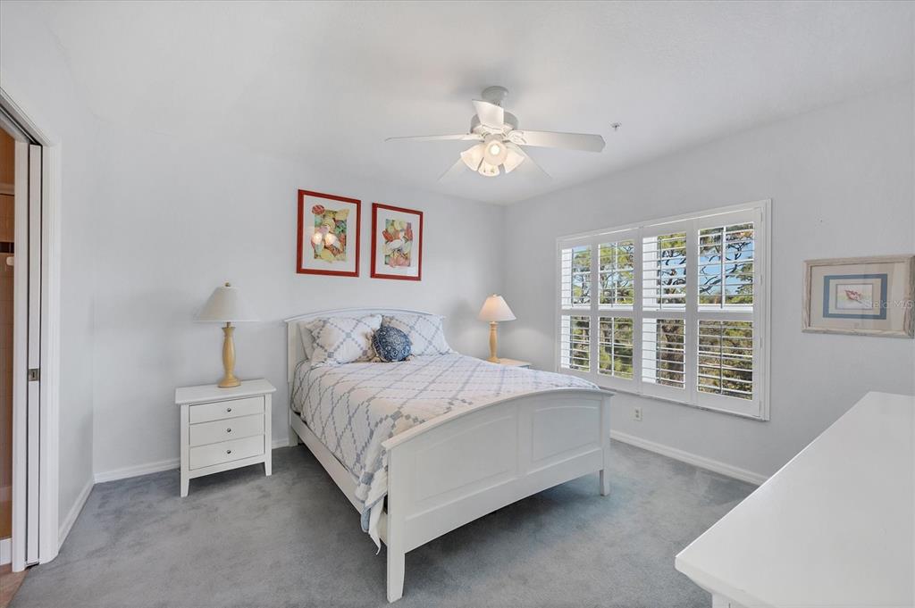 8413 Placida Road, Unit 308 Placida, FL 33946 - Photo 14 of 40 a bedroom with a large bed and a window