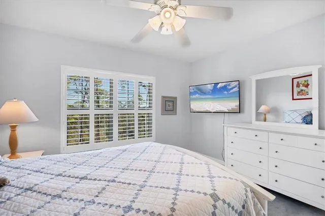 a bedroom with a large bed and a window