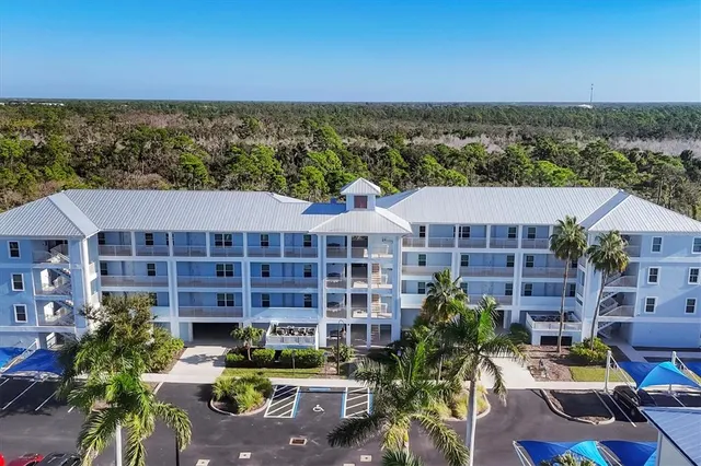 a view of a building with garden space and sitting area