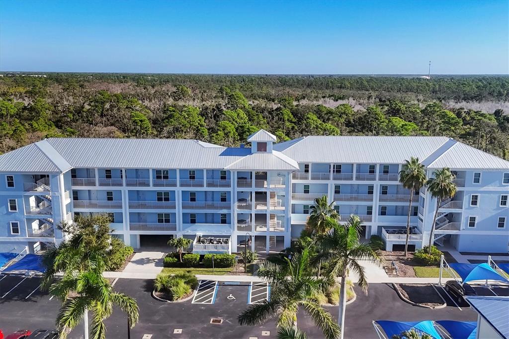 8413 Placida Road, Unit 308 Placida, FL 33946 - Photo 2 of 40 a view of a building with garden space and sitting area