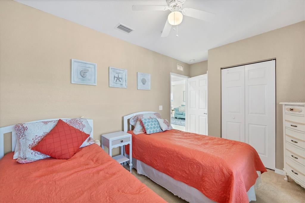 8413 Placida Road, Unit 308 Placida, FL 33946 - Photo 21 of 40 a bedroom with two beds and a chandelier