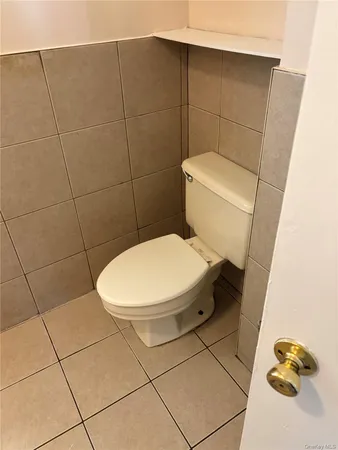 a white toilet sitting next to a bathroom sink
