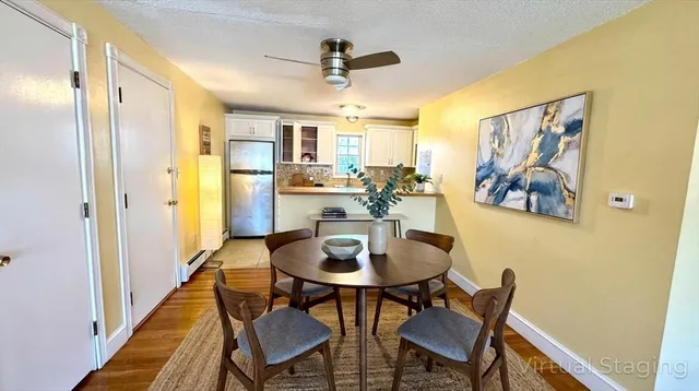 a view of a dining room with furniture and a chandelier