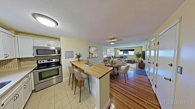 a kitchen with stainless steel appliances granite countertop a stove refrigerator and a refrigerator
