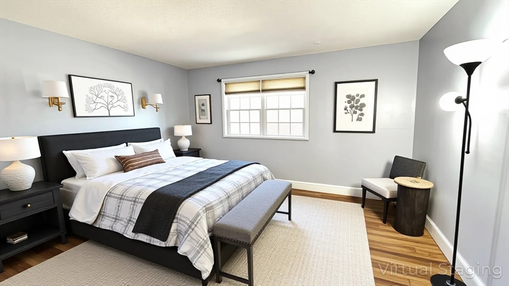 31 Arlington Road, Unit 6 Woburn, MA 01801 - Photo 6 of 26 a bedroom with a bed and wooden floor