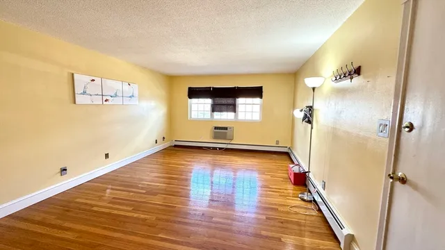 a view of a room with wooden floor and staircase