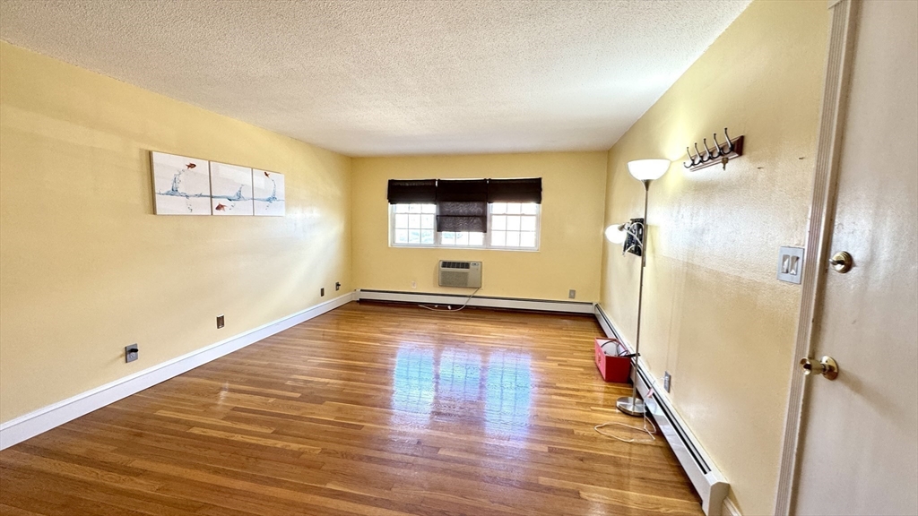 31 Arlington Road, Unit 6 Woburn, MA 01801 - Photo 9 of 26 a view of a room with wooden floor and staircase