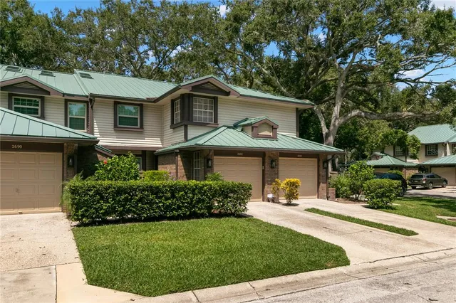 a front view of a house with a yard garage and outdoor seating