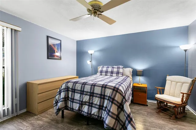 a bedroom with a bed and a chair