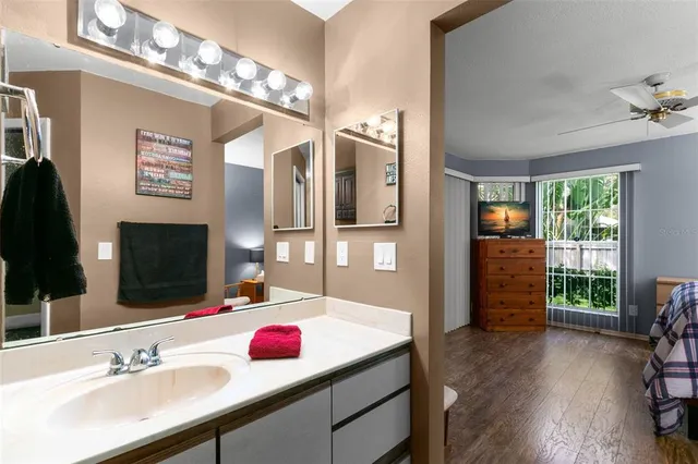 a bathroom with a sink double vanity granite and a shower